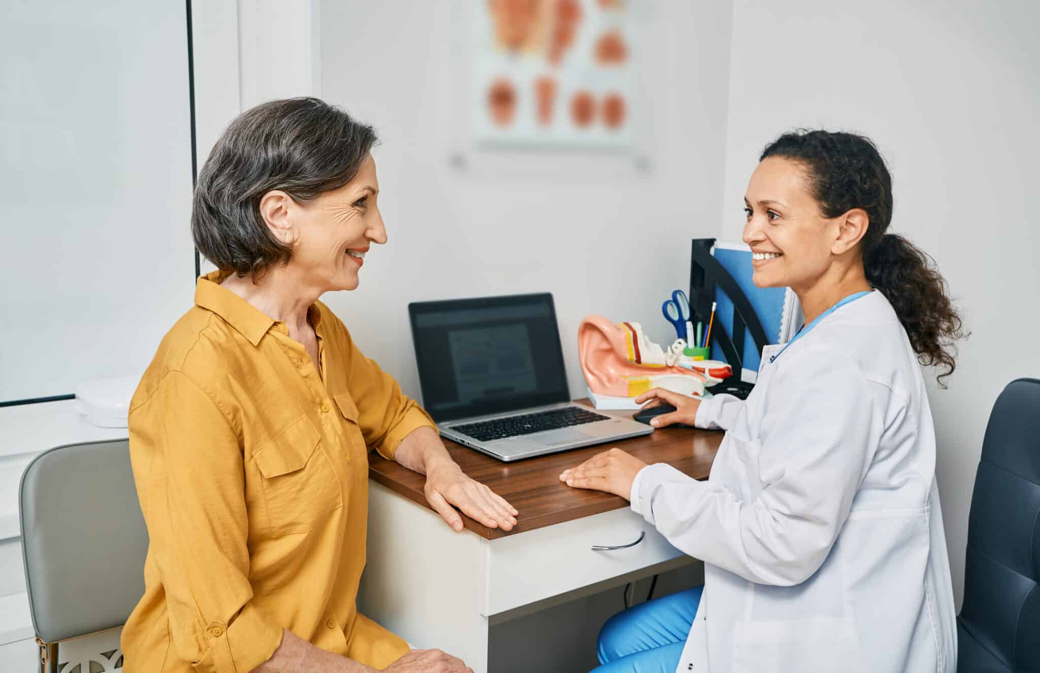 Woman attending a consultation with an audiologist to discuss hearing loss.
