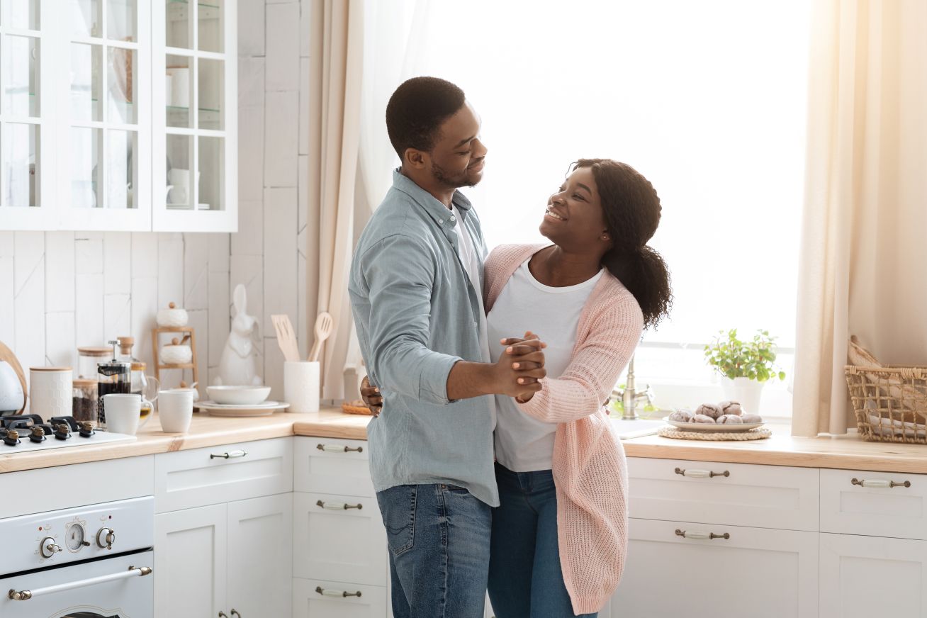 couple treating hearing loss with implants man dancing with woman after receiving implantable hearing aids